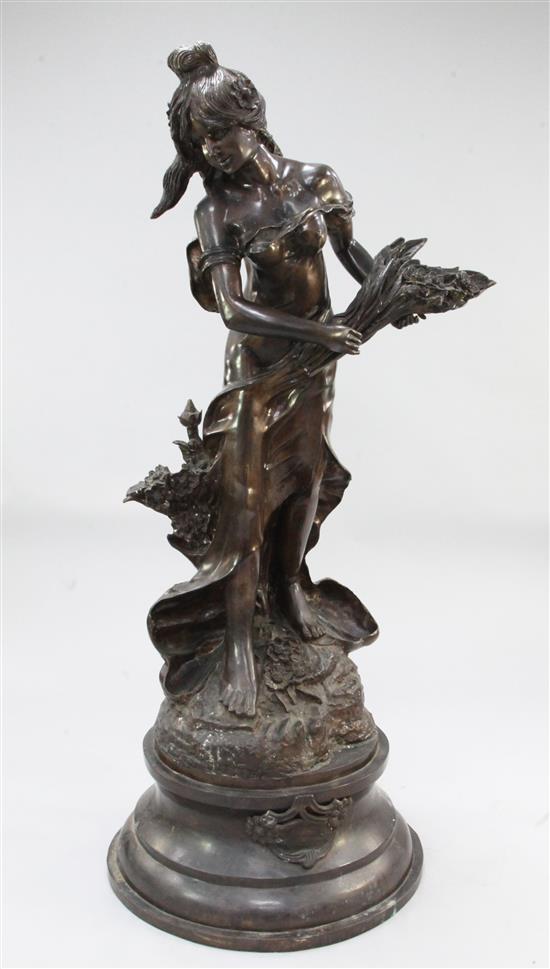 After Auguste Moreau. A large Art Nouveau style bronze figure of a maiden holding flowers, 65in.